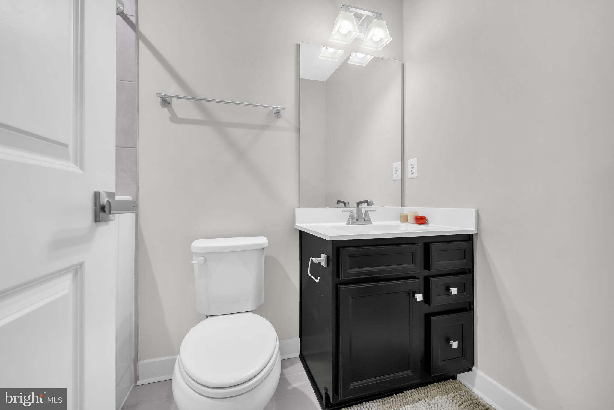 7111 Sollers Point Road Baltimore, MD 21222 - Photo 31 of 61 a bathroom with a sink vanity mirror and toilet