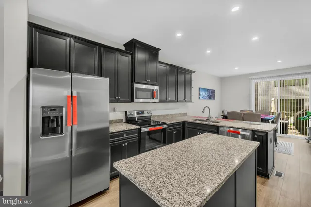 a dining room with furniture wooden floor and a potted plant