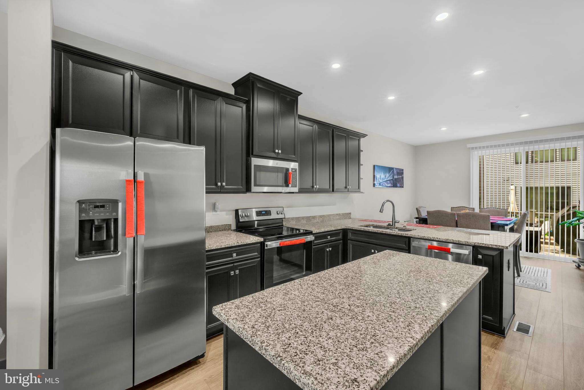 7111 Sollers Point Road Baltimore, MD 21222 - Photo 5 of 61 a kitchen with stainless steel appliances granite countertop sink stove refrigerator and cabinets