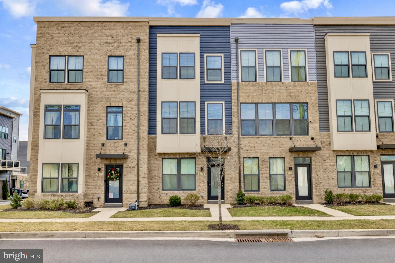 7111 Sollers Point Road Baltimore, MD 21222 - Photo 52 of 61 a front view of a brick building next to a yard