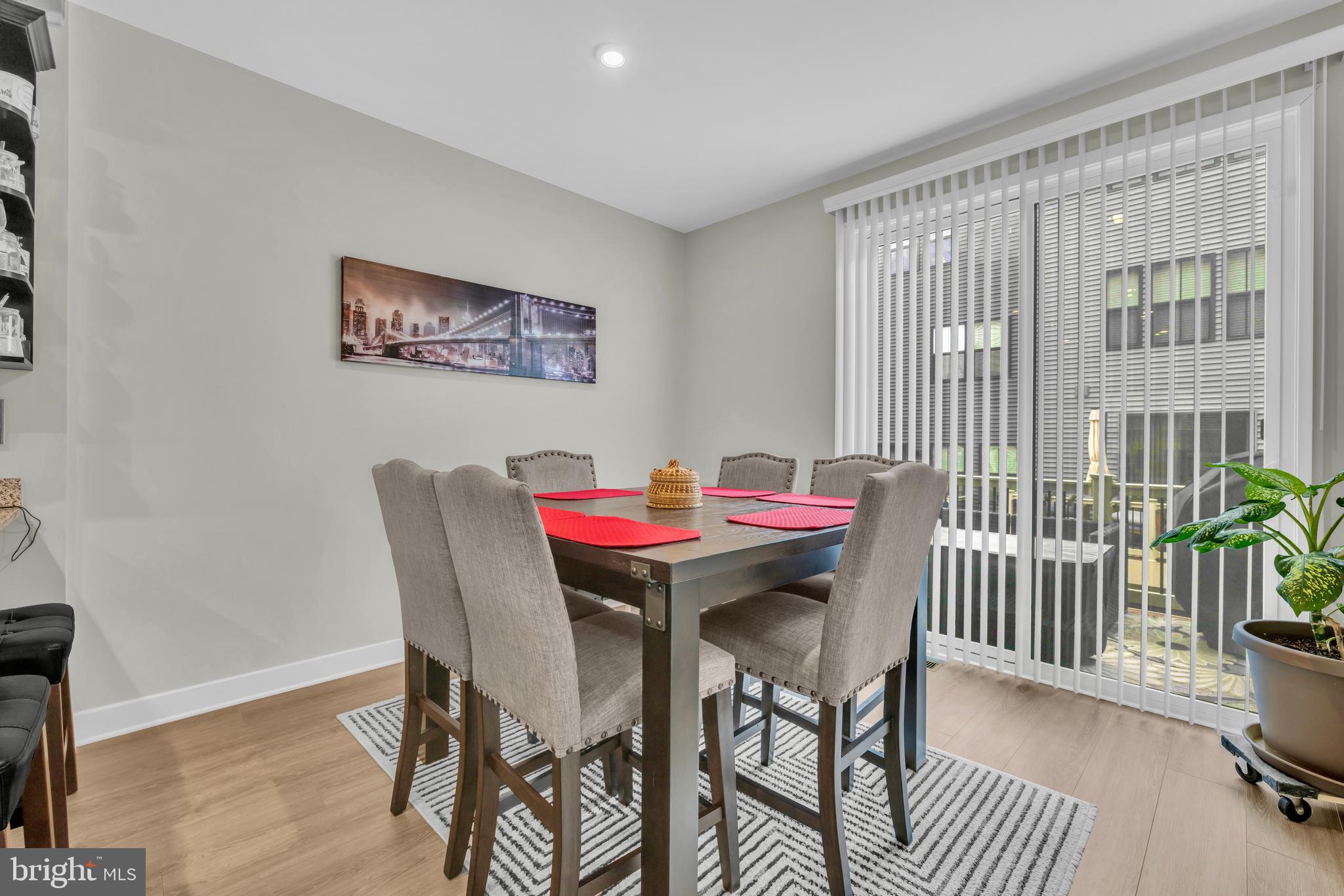7111 Sollers Point Road Baltimore, MD 21222 - Photo 6 of 61 a dining room with furniture wooden floor and a potted plant