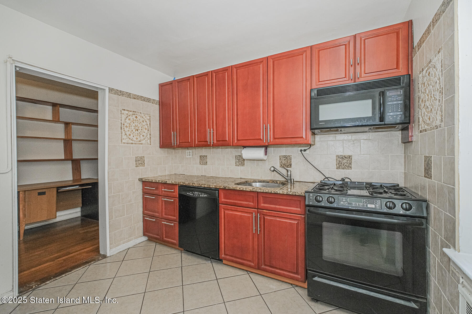 36 Dahill Road, Unit 4F Brooklyn, NY 11218 - Photo 9 of 25 a kitchen with stainless steel appliances granite countertop a stove top oven microwave and cabinets