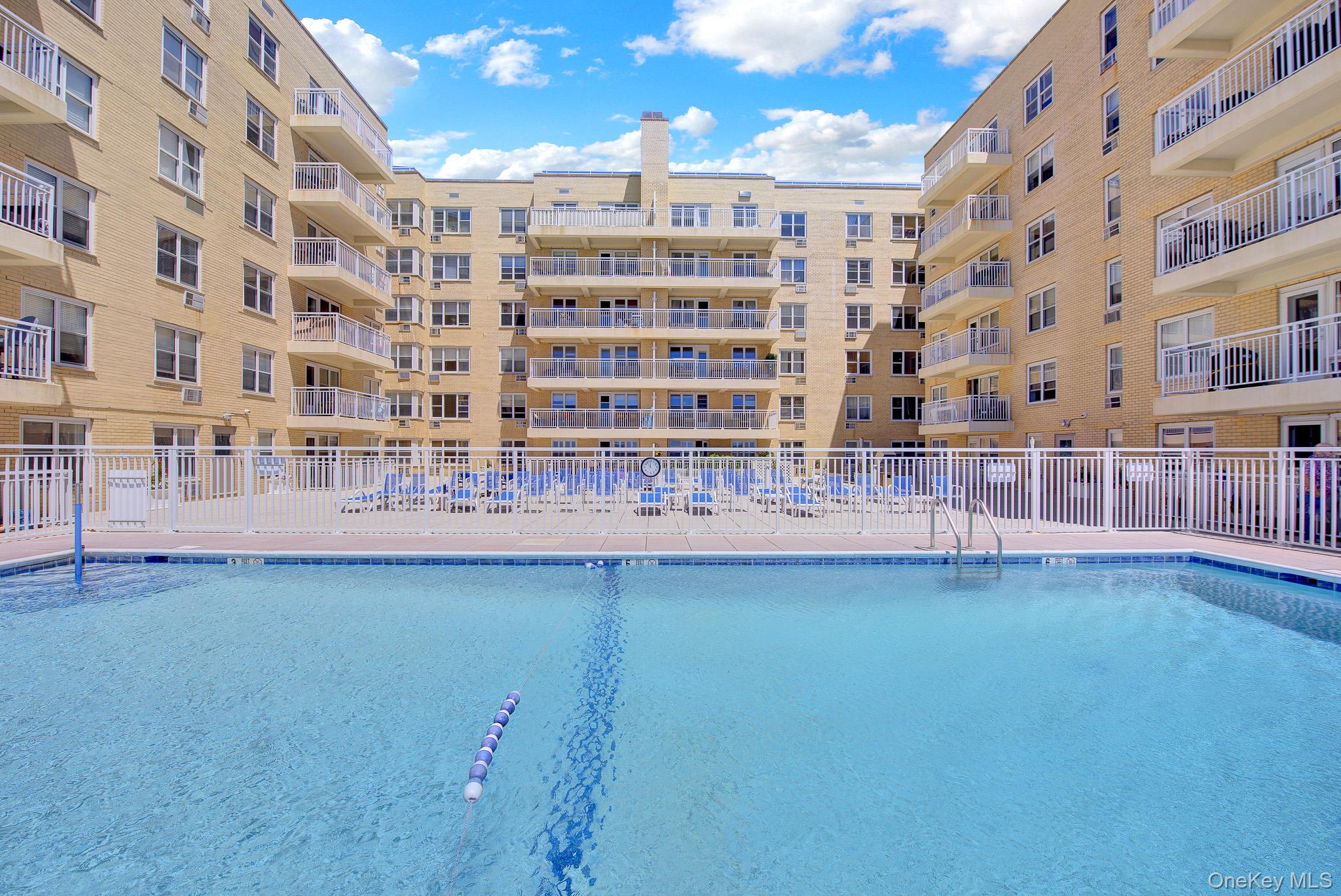 700 Shore Road, Unit 5M Long Beach, NY 11561 - Photo 27 of 34 View 2 Of Heated Salt Water Swimming Pool. And Rear View Of Pool Deck And Building.