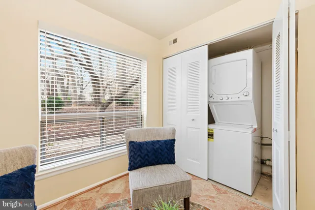a view of kitchen with furniture and refrigerator