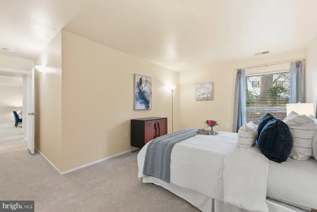 a bedroom with a bed and window