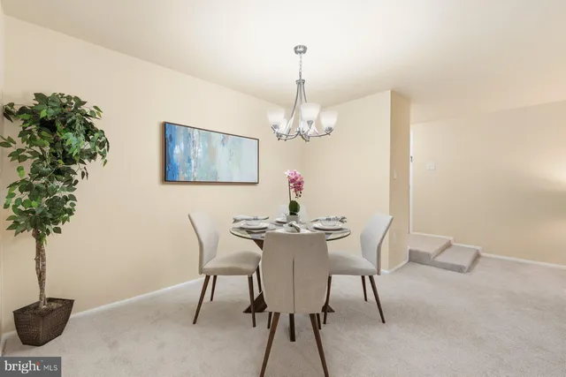 a view of a dining room with furniture and chandelier