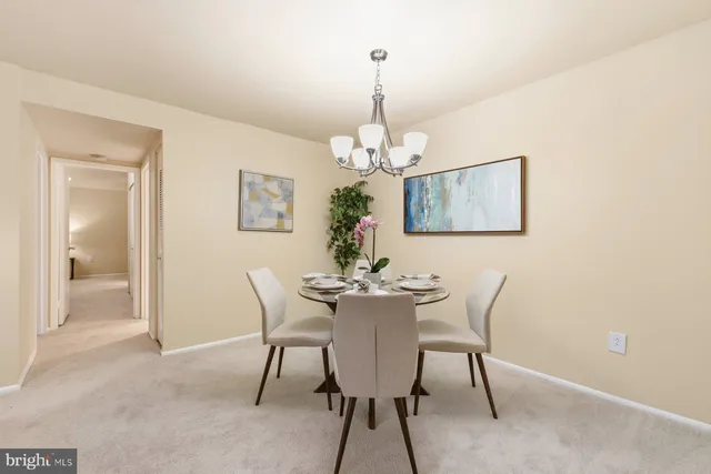a dining room with furniture and chandelier