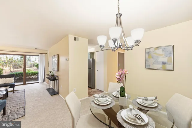 a view of a dining room with furniture large windows and wooden floor