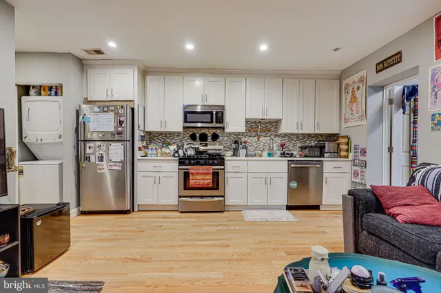 a kitchen with stainless steel appliances granite countertop a refrigerator sink and stove
