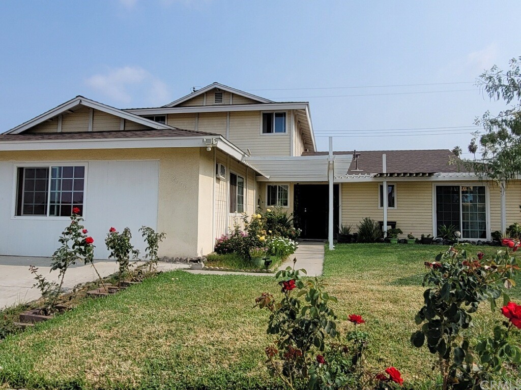12660 Buttonwood Circle Riverside, CA 92503 - Photo 1 of 1 a front view of a house with a garden