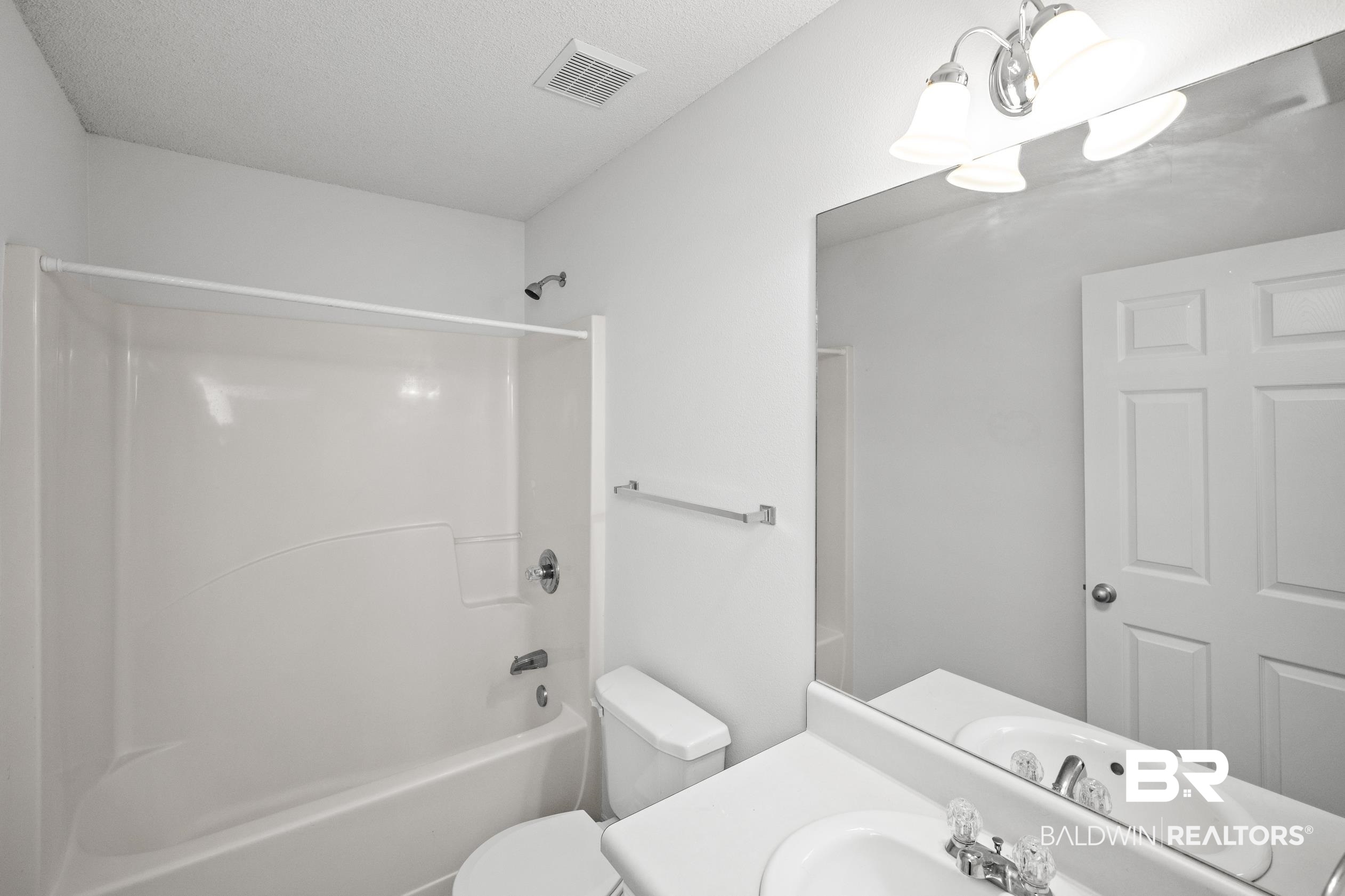 306 Monteith Oaks Drive Foley, AL 36535 - Photo 20 of 38 Bathroom featuring bathtub / shower combination, vanity, and a chandelier
