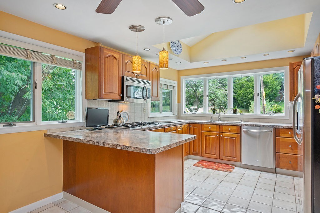 81 Cornell Road Marblehead, MA 01945 - Photo 8 of 28 a kitchen with stainless steel appliances granite countertop a sink stove and cabinets