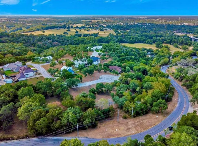 an aerial view of a houses with a yard