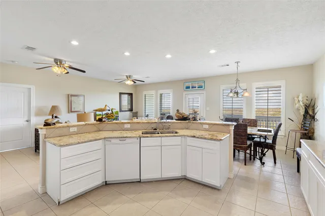 a kitchen with a sink and chairs