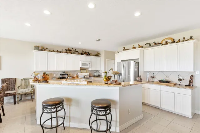 a kitchen with a sink a stove and cabinets