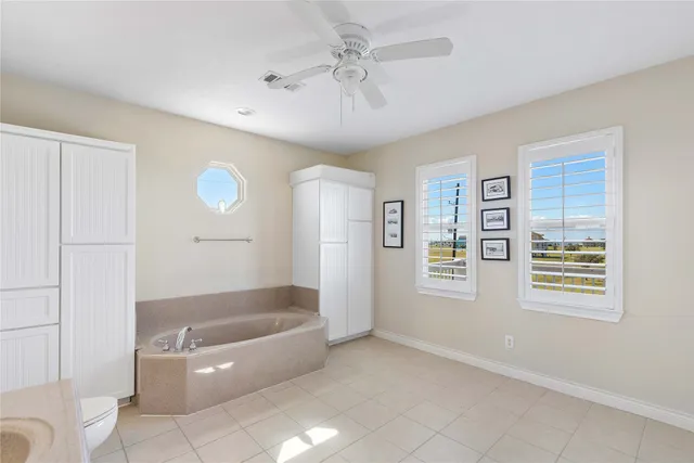 a bathroom with a tub shower and sink