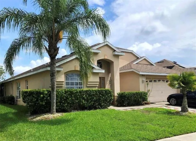 a front view of house with yard and green space
