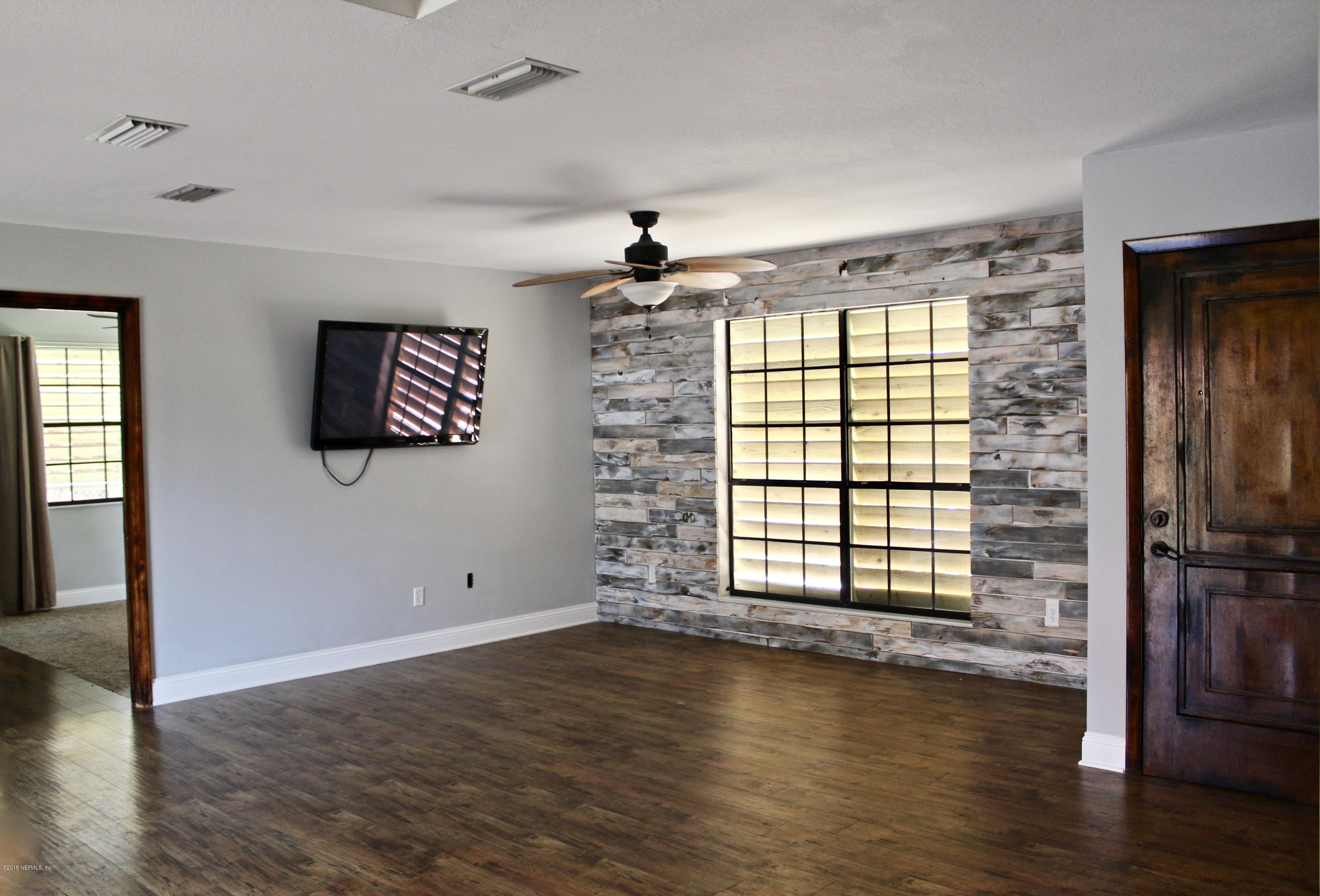 461 Gerona Road St. Augustine, FL 32086 - Photo 5 of 52 wooden floor in an empty room with a window