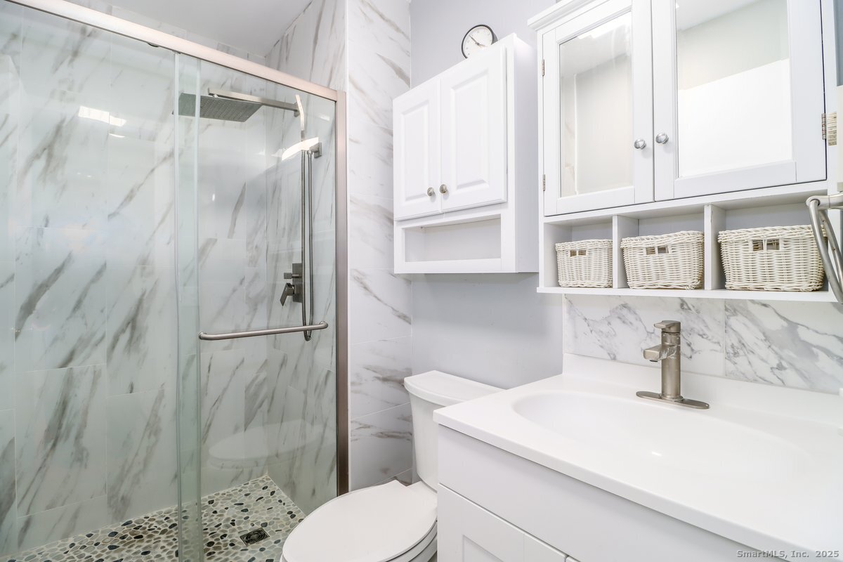 25 Padanaram Road, Unit 30 Danbury, CT 06811 - Photo 11 of 24 a bathroom with a sink toilet and shower