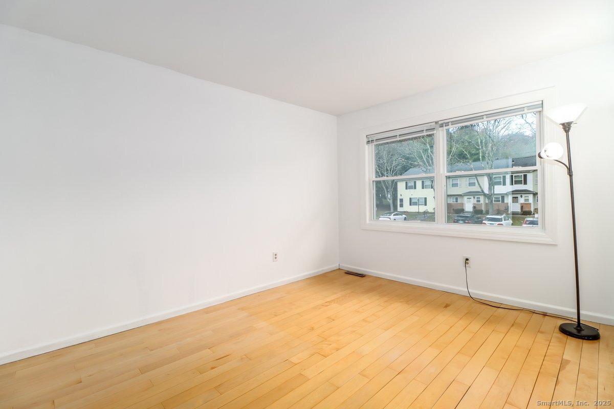 25 Padanaram Road, Unit 30 Danbury, CT 06811 - Photo 13 of 24 wooden floor in an empty room with a window