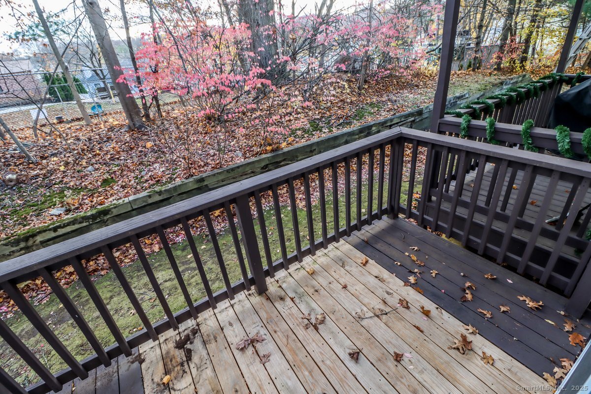 25 Padanaram Road, Unit 30 Danbury, CT 06811 - Photo 18 of 24 a view of balcony with wooden floor and fence