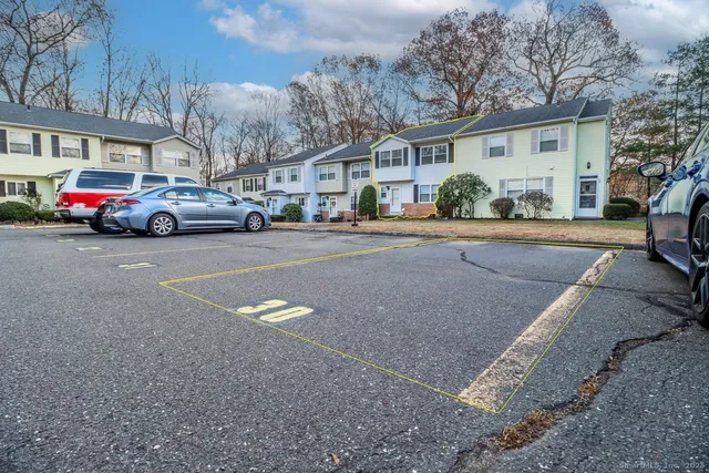 a view of a cars park in front of a building