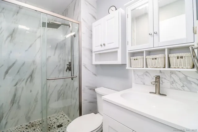 a bathroom with a sink toilet and shower