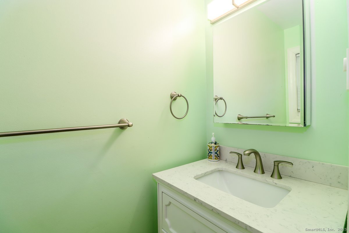 25 Padanaram Road, Unit 30 Danbury, CT 06811 - Photo 8 of 24 a bathroom with a sink and a mirror