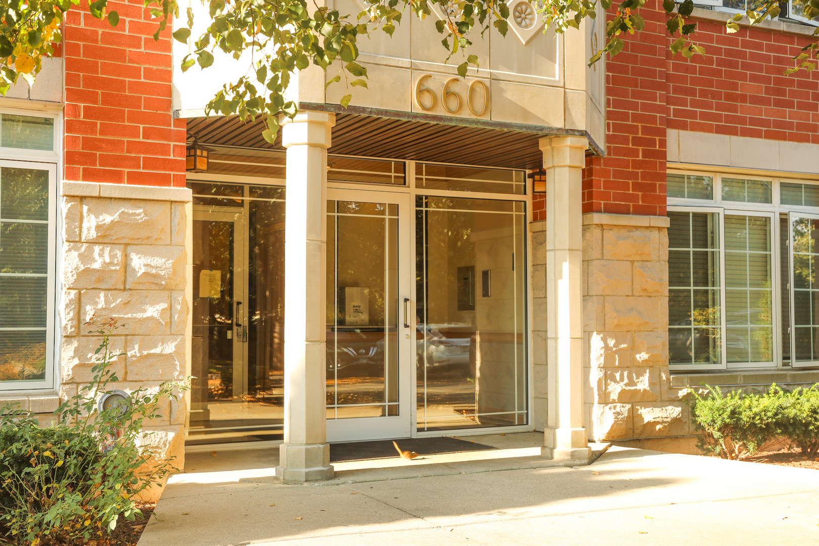 660 McHenry Road, Unit 204 Wheeling, IL 60090 - Photo 1 of 34 a view of a brick house with a outdoor space