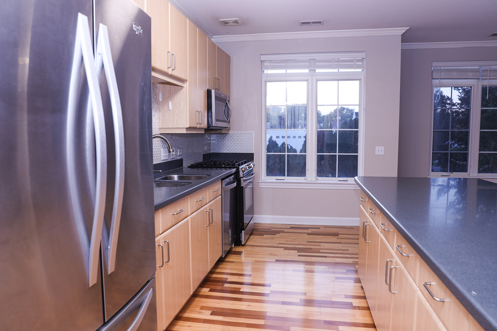 660 McHenry Road, Unit 204 Wheeling, IL 60090 - Photo 11 of 34 a view of a kitchen with stainless steel appliances granite countertop a refrigerator and a sink