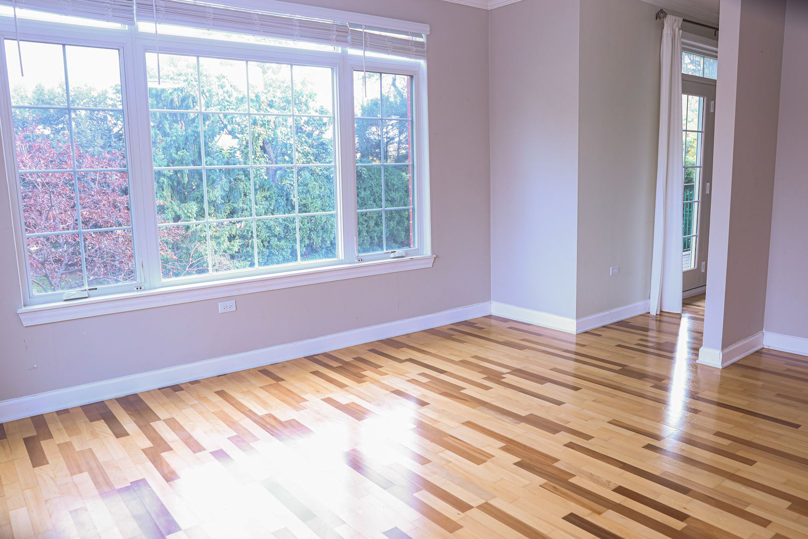 660 McHenry Road, Unit 204 Wheeling, IL 60090 - Photo 17 of 34 a view of empty room with wooden floor and fan