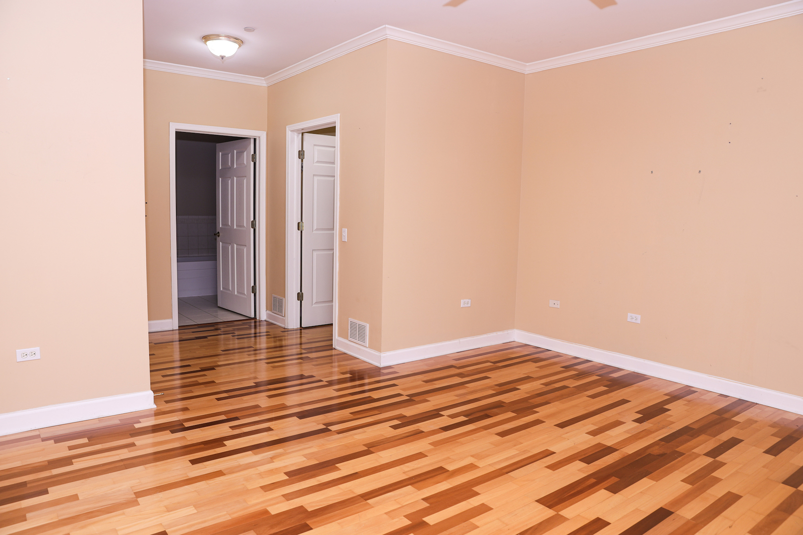 660 McHenry Road, Unit 204 Wheeling, IL 60090 - Photo 20 of 34 a view of a livingroom with wooden floor and an entryway
