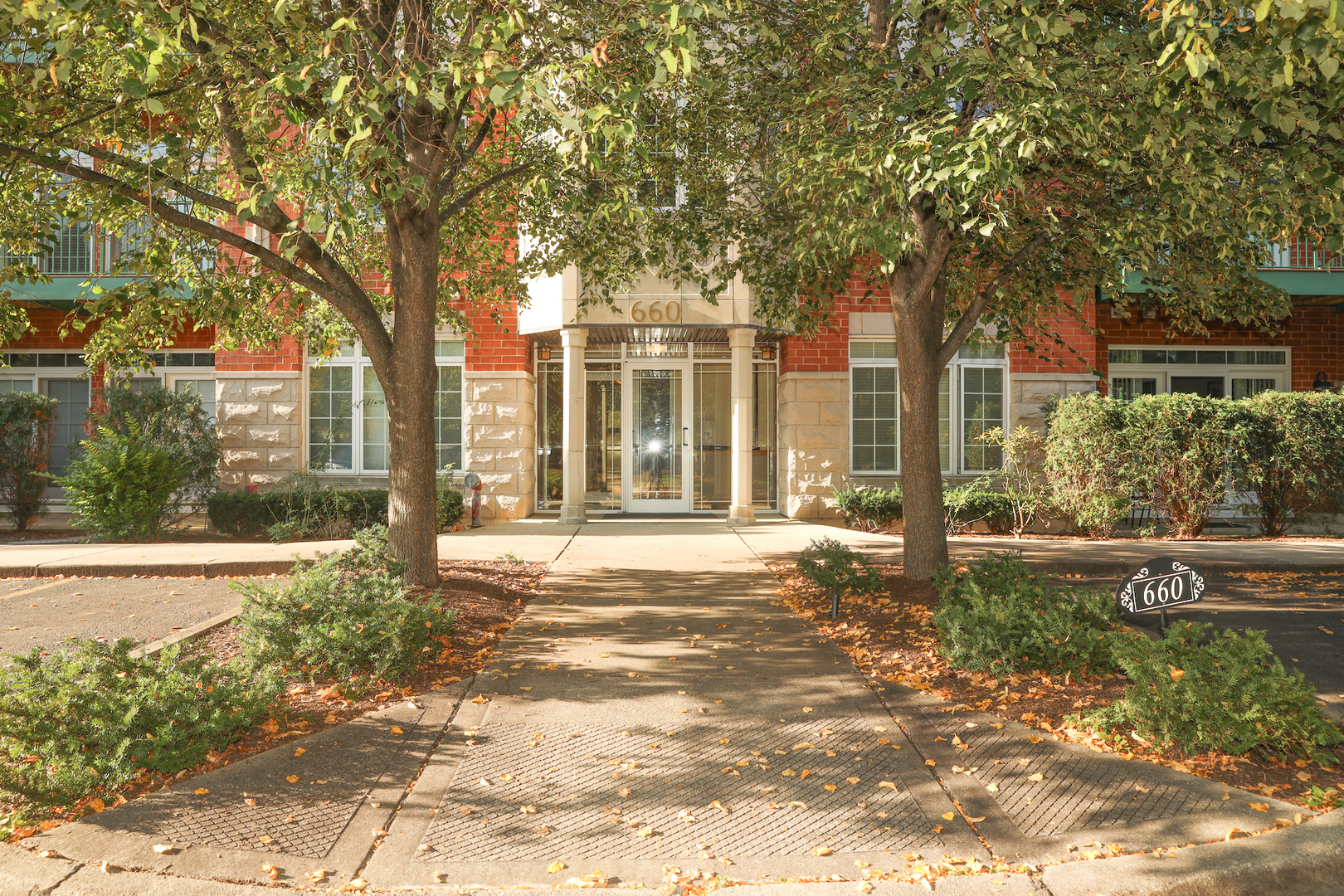 660 McHenry Road, Unit 204 Wheeling, IL 60090 - Photo 2 of 34 a house with trees in the background