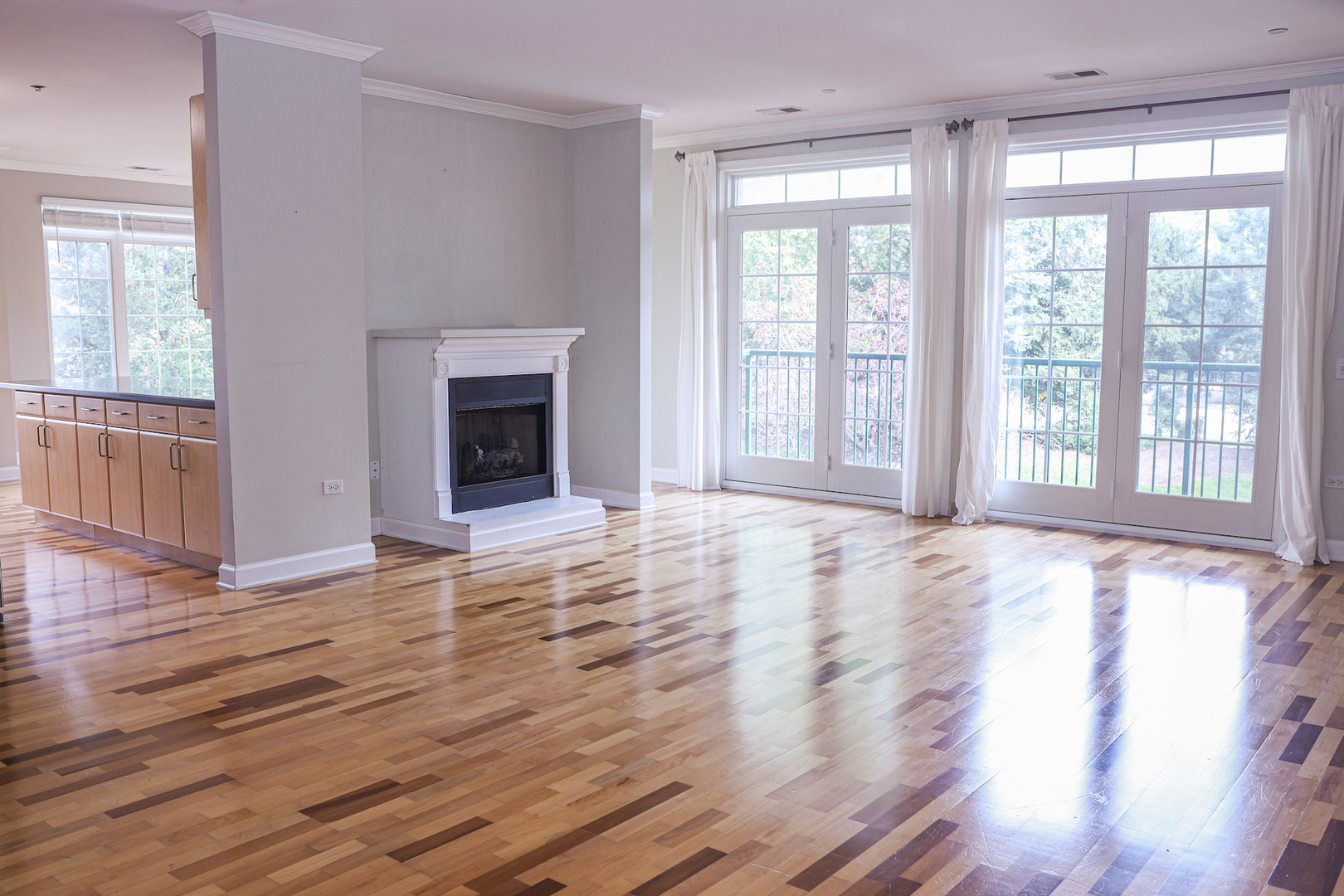 660 McHenry Road, Unit 204 Wheeling, IL 60090 - Photo 5 of 34 a view of an empty room with wooden floor and a window
