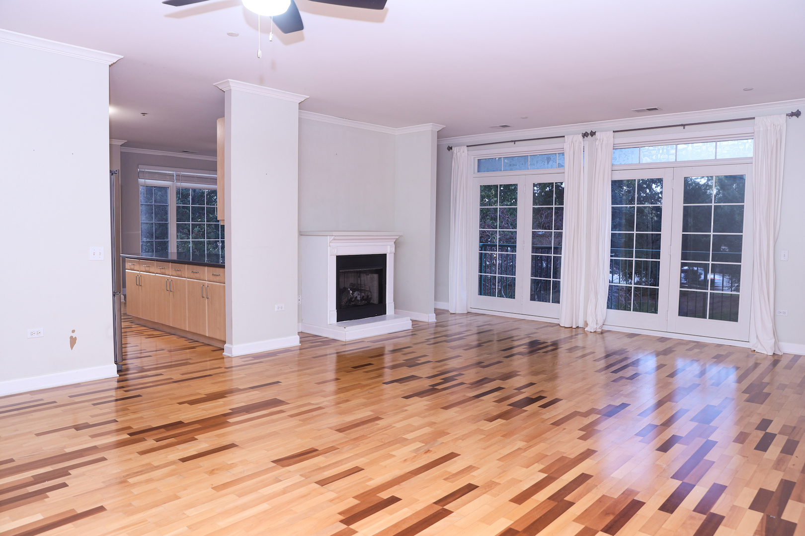 660 McHenry Road, Unit 204 Wheeling, IL 60090 - Photo 6 of 34 a view of empty room with wooden floor and fireplace