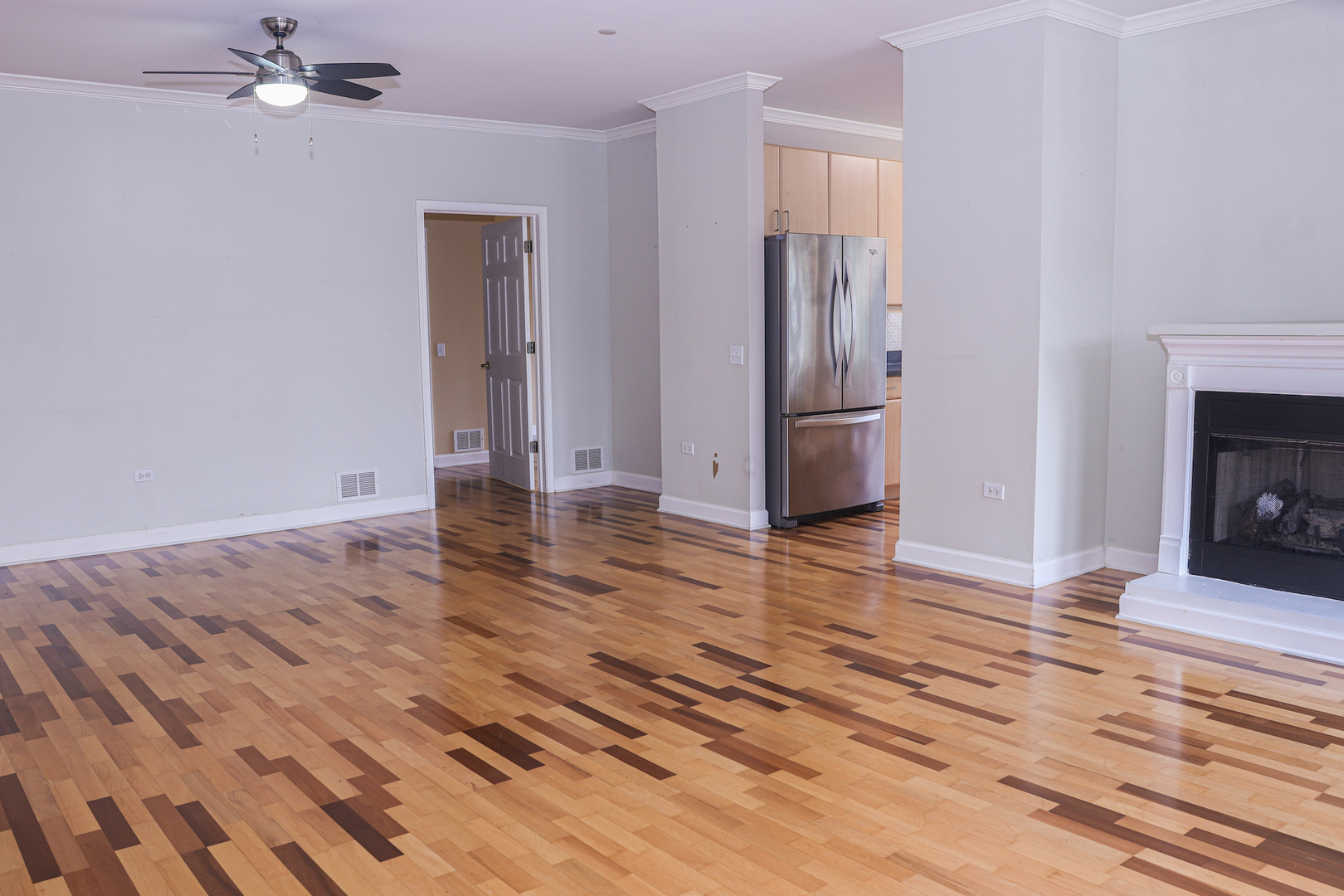 660 McHenry Road, Unit 204 Wheeling, IL 60090 - Photo 9 of 34 a view of empty room with wooden floor and fireplace