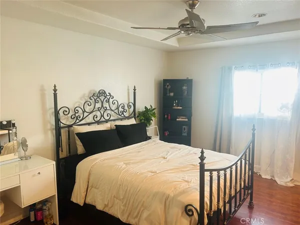 a bedroom with a bed and a chandelier