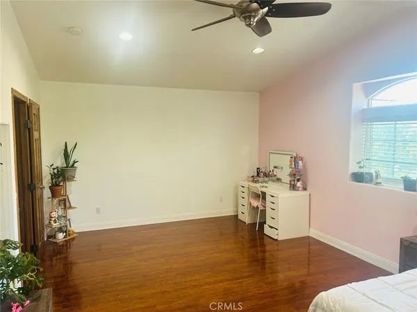 a view of a room with a window and wooden floor