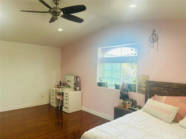 a bedroom with furniture and a wooden floor