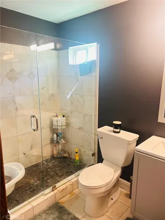 a white toilet sitting next to a bathroom sink