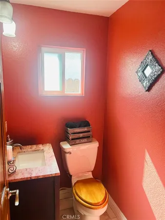 a bathroom with a toilet a sink and mirror