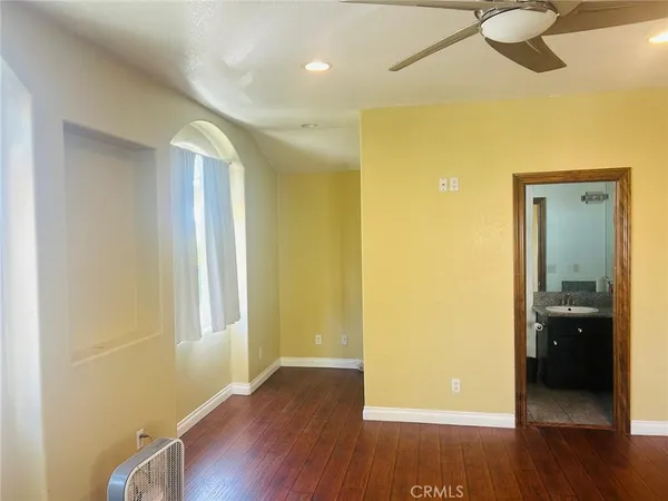 a view of a room with wooden floor and door