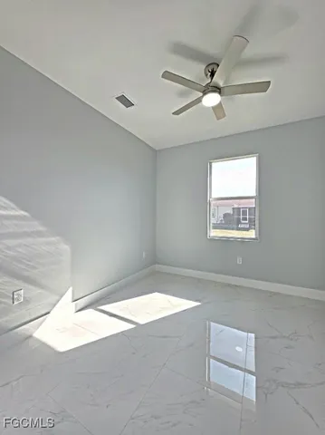a view of a big room with carpet and windows