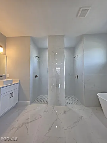 a bathroom with a granite countertop sink a toilet and shower