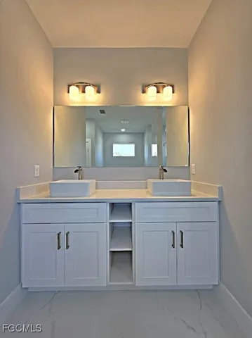 a bathroom with a double vanity sink and a mirror