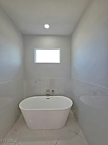 a bathroom with a bathtub and window