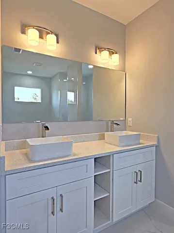 a bathroom with a sink and a mirror