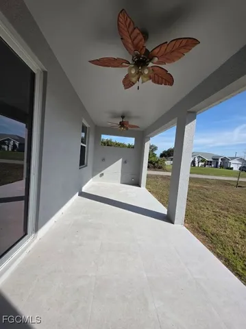 a view of a room with a ceiling fan
