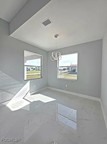 a view of an empty room with windows