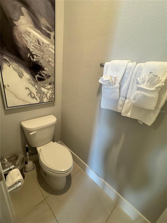 7770 Sandy Ridge Drive, Unit 210 Reunion, FL 34747 - Photo 21 of 42 a white toilet sitting next to a shower curtain